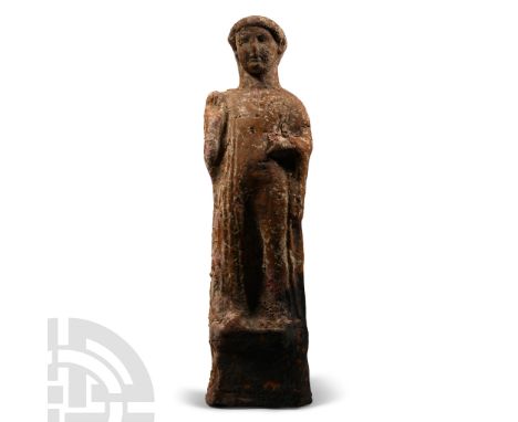 4th century B.C. Hollow-formed standing male in floor-length robe with copious sleeves, the left hand held across the chest a