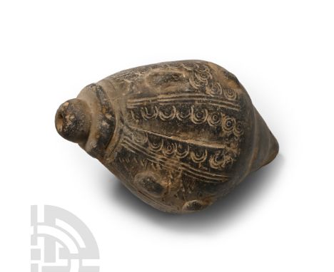 13th-15th century A.D. A piriform missile with raised lugs arranged in pairs, impressed lines and concentric circles in betwe