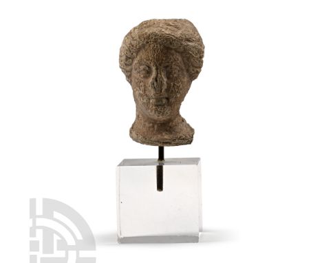 3rd-4th century A.D. Modelled in the round as a facing female, semi-naturalistic facial detailing and dressed hair; mounted o