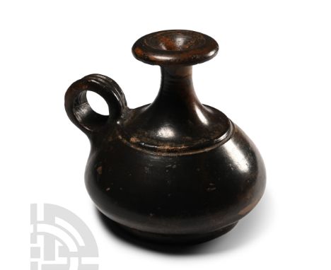 Circa 350 B.C. With carination and off-set ring at shoulder, loop handle with triple-band profile; slender neck and flaring l