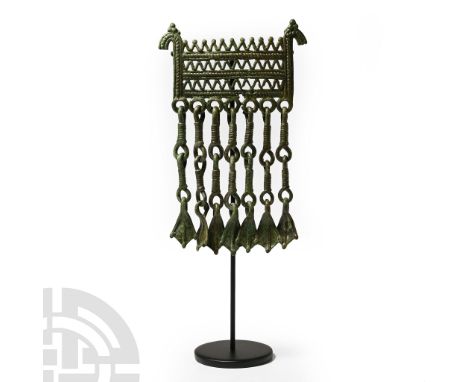 8th-10th century A.D. Comprising three rows of latticework with horse-head finials above, loops to the lower edge with articu