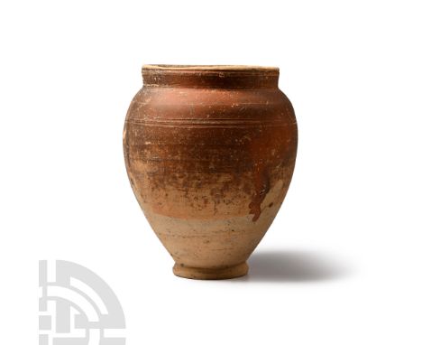 Circa 3rd century A.D. Piriform in profile with flared base and broad mouth, circumferential lines.  263 grams, 13 cm (5 1/8 