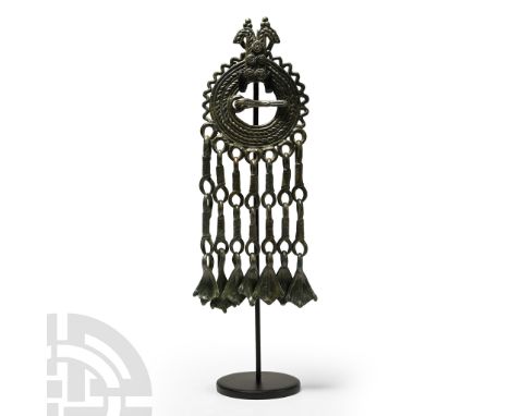 8th-10th century A.D. Annular brooch with ropework detailing to the hoop, addorsed horse-heads above and zigzag band to the r