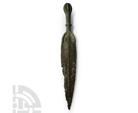 Late 2nd-early 1st millennium B.C. The hilt with flanged pommel, round grip with horizontal flange, crescentic guard, long fo