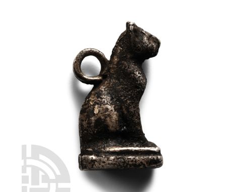 Late-Ptolemaic Period, 664-30 B.C. Seated figure of a cat with pointed ears mounted on a rectangular base with a rounded end;