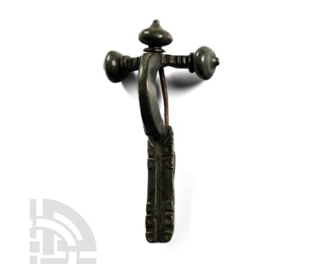 4th century A.D. Onion knop finials, the left finial with incised X-motif, deep bow, stepped junction with foot, trapezoidal 