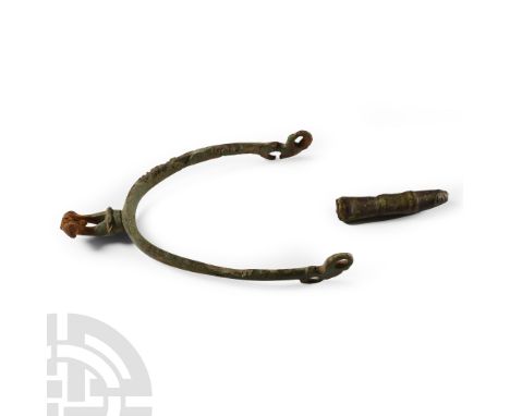 8th-17th century A.D. Comprising: a Saxon strap end with rounded point and ring-and-dot decoration; a post medieval rowel spu