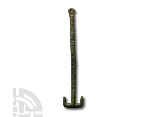 Circa 6th century A.D. With round-section hatched shank and T-shaped finial with swept wings. Cf. MacGregor, A. &amp; Bolick,