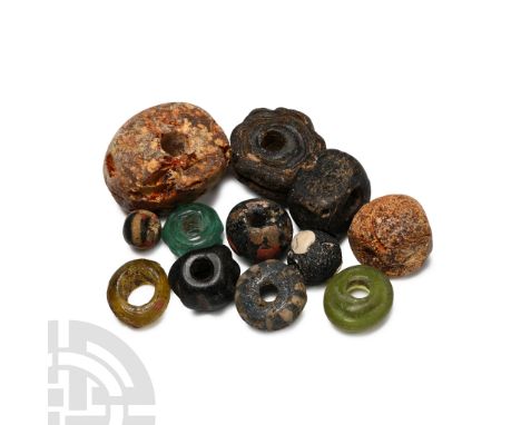 Circa 5th-7th century A.D. Including annular, melon and biconvex types in glass and amber.  26.6 grams total, 8-25 mm (1/4 - 