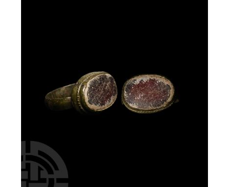14th-15th century A.D. Flat-section hoop with ribbed underside, ellipsoid bezel with inset glass cloison.  4.90 grams, 24.39 