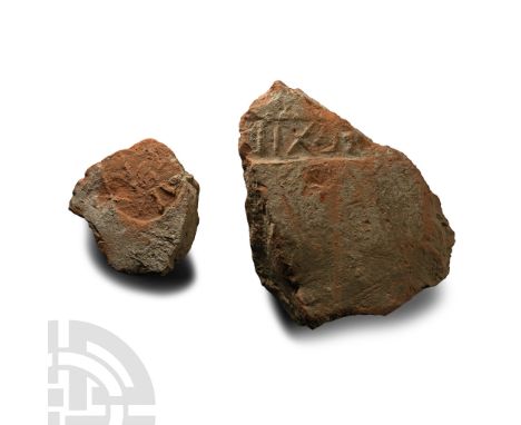 1st-2nd century A.D. Two fragments of ceramic brick with impressed stamps: '[.]EGXII' on the larger and a disc on the other w