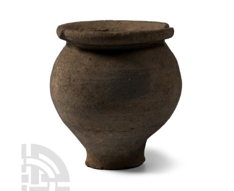 2nd-3rd century A.D. Comprising a broad globular body on a narrow foot, with sharply everted rim; partly absent.  163 grams, 