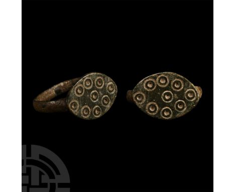 14th-15th century A.D. With a slender D-section hoop and large lentoid bezel with punched ring-and-dot motifs.  2.91 grams, 1
