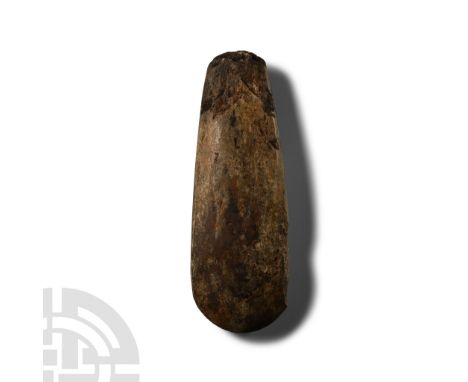 Neolithic Period, circa 6000 B.P. Lentoid in section with broad square butt and curved edge, finely polished. Cf. MacGregor, 