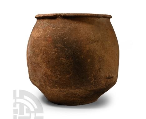 Iron Age, Cypro-Geometric, circa 950-850 B.C. Drum-shaped in profile with carination above the foot, rolled rim to the mouth;