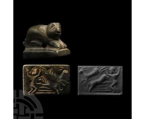 1st millennium B.C. Carved in the round crouching lion with head slightly turned, on a rectangular base; intaglio beast-tamer