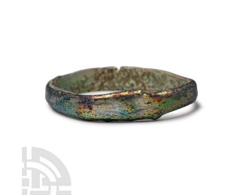 3rd-4th century A.D. D-shaped in section with iridescent surface.  3.09 grams, 38 mm (1 1/2 in.). [No Reserve] From an old En