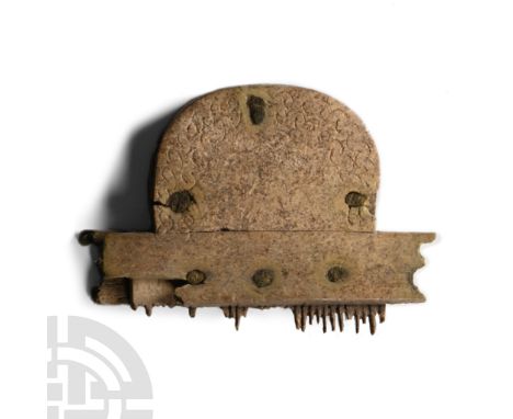 Circa 9th-11th century A.D. Constructed from piled bone panels held with iron rivets; median D-shaped panel with teeth cut in