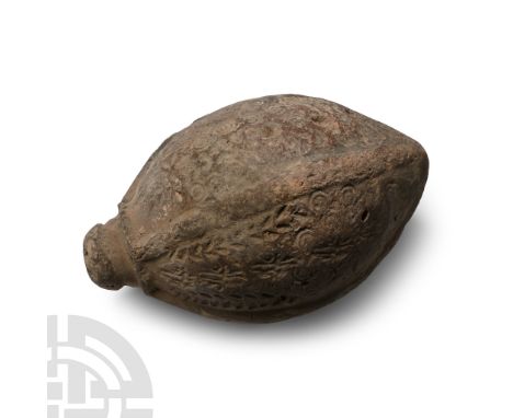 9th-11th century A.D. A large piriform missile with raised lugs and impressed circle-and-dot motifs, intended to be filled wi