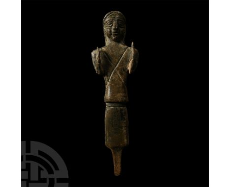 Late 2nd-early 1st millennium B.C. Columnar in form with rounded facial features, bisected headdress, incised saltire to the 
