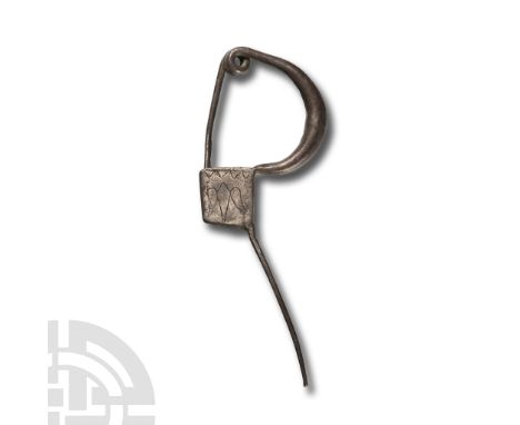 5th-4th century B.C. Comprising a thick round-section bow tapering to each end; the forward end developing to a two-coiled sp