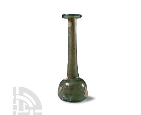 1st-2nd century A.D. With plano-convex body and flat base, tapering neck and everted rim; some iridescence to surface. Cf. Wh