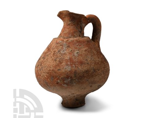 1st-4th century A.D. Biconvex in profile with narrow base, stepped shoulder, pinched rim with pouring spout, strap handle; ap