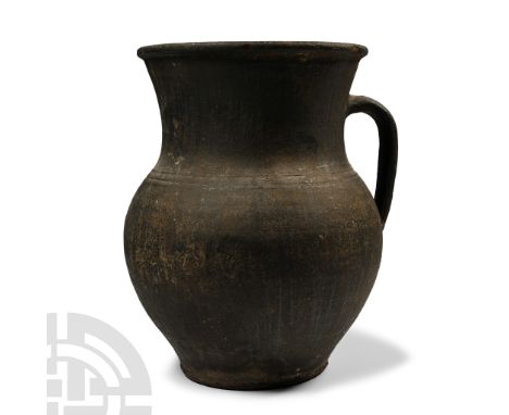 Roman, 3rd-4th century A.D. or later. Comprising an ovoid body with flat base, broad neck and wide mouth with carinated rolle