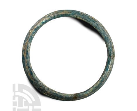 Circa 4th century A.D. D-shaped in section with slightly ribbed outer face. Cf. Kunstmuseum Luzern, 3000 Jahre Glaskunst, Luz