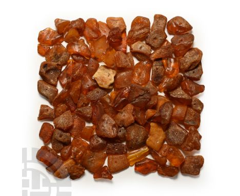 Oligocene Period, circa 45 million years B.P. A large group of unpolished amber pieces, each pierced through the centre for s