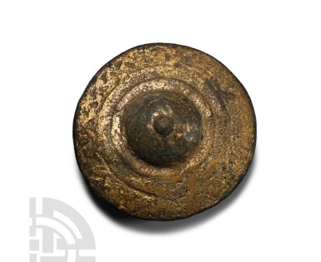 1st-3rd century A.D. Broad disc with concentric circles, central dome with knop, two attachment pins to reverse. Cf. similar 