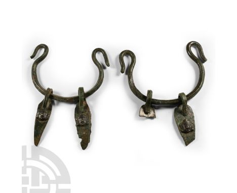1st-2nd century A.D. Matched pair of drop-handles for a situla or other large vessel, each an arched rod with curved and retu