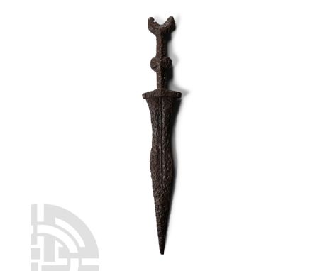 2nd century B.C. A pugio military dagger with waisted leaf-shaped blade, rounded midrib, rectangular rivetted baluster, short