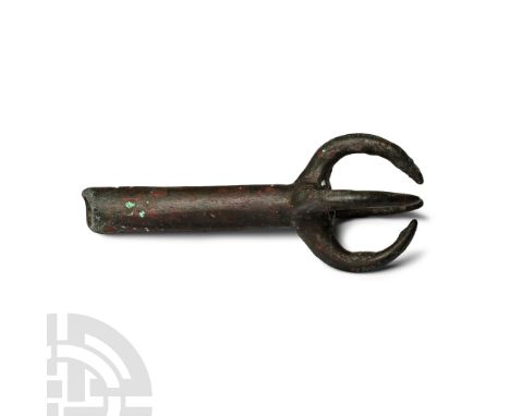 1st-4th century A.D. With tapering tubular shank, pierced at the open end, four tapering integral hooks forming a claw-settin