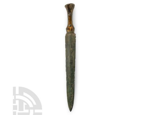 10th century B.C. A short sword with lentoid-section triangular blade, rhomboid guard, hilt with later organic filling to eac
