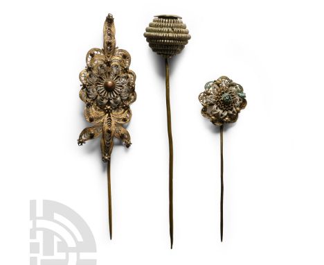 Circa 18th-19th century A.D. Comprising: pin with hollow-formed stepped bulb; pin with canatille rosette; pin with canatille 