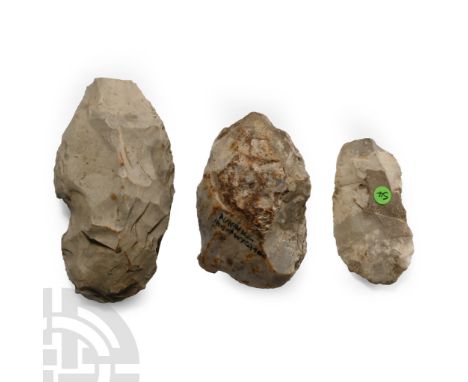 Neolithic Period, 6th-4th millennium B.P. Group of three lentoid-section tools each with a worked edge and irregular butt; on