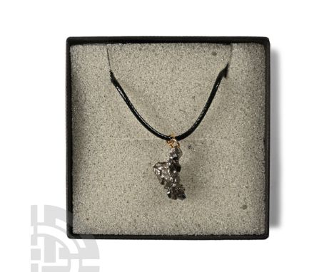 Fell 6000-5000 years B.P. Comprising a section of nickel-iron meteorite (IAB) set with a suspension loop and suspended from a
