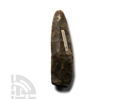 Neolithic Period, circa 6000 B.P. Lentoid in section with broad square butt and long rounded cutting edge; unpolished; old fi