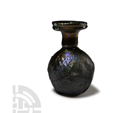 1st-2nd century A.D. With bulbous body and regular pattern of shallow dimples, flat base, narrow obstructed neck, mouth with 