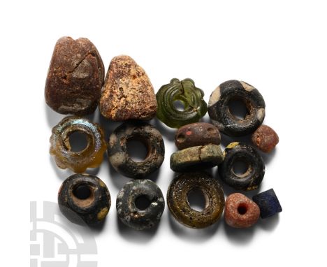 Circa 5th-7th century A.D. Comprising mainly annular types in glass, some with marvered trails.  22 grams total, 6-20 mm (2 3