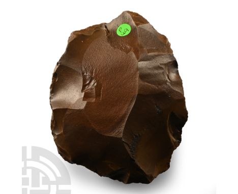 Lower Palaeolithic Period, 450,000-280,000 B.P. Lentoid in section with irregular edge, cortex to one face; collector's label