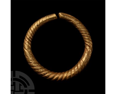 Mid 1st millennium B.C. or later. Penannular in form and round in section with twist-pattern detailing. Cf. MacGregor, A. (ed