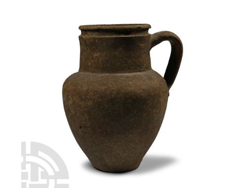 3rd-4th century A.D. Comprising a piriform coarseware body with broad carinated shoulder and low neck, strap handle and reces
