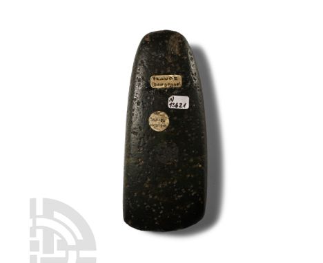 Neolithic Period, circa 5500-2200 B.P. Rectangular in section with a narrow rounded butt and asymmetrical curved edge; pitted