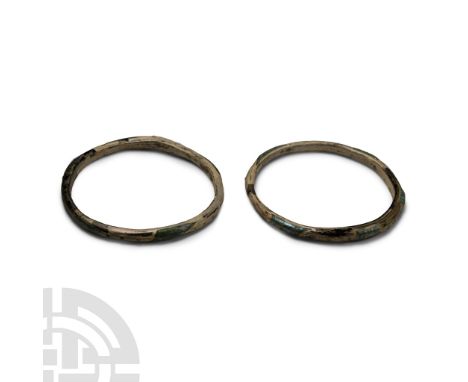 3rd-4th century A.D. Each a slender D-section hoop with some iridescent surface. Cf. Kunstmuseum Luzern, 3000 Jahre Glaskunst