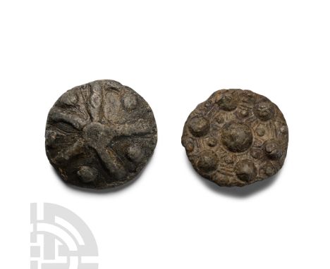 9th-11th century A.D. Comprising: one plano-convex in profile with radiating arms and pellets, ferrous remains to reverse; on