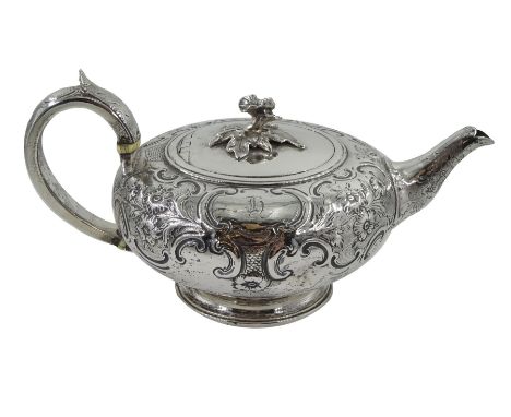 George III silver teapot, squat form, embossed foliate decoration, leaf-capped handle by John Emes, London 1807 with later fl
