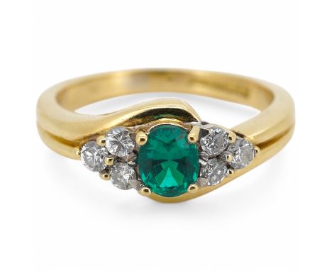A synthetic emerald and diamond ring, claw-set with an oval synthetic emerald between trios of brilliant-cut diamonds, mounte