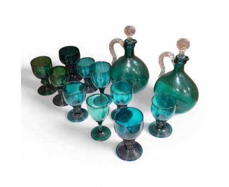 A collection of antique green glassware to include two mid 19th century decanters, roemers etc. largest 23cm high. Condition 